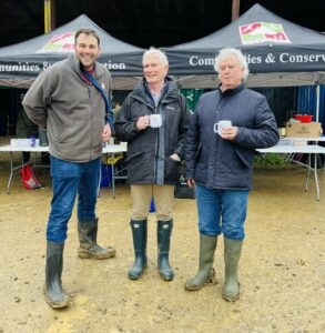 John Shaw, Moir Stewart & Robin Walker in Wellington boots enjoying a cup of tea