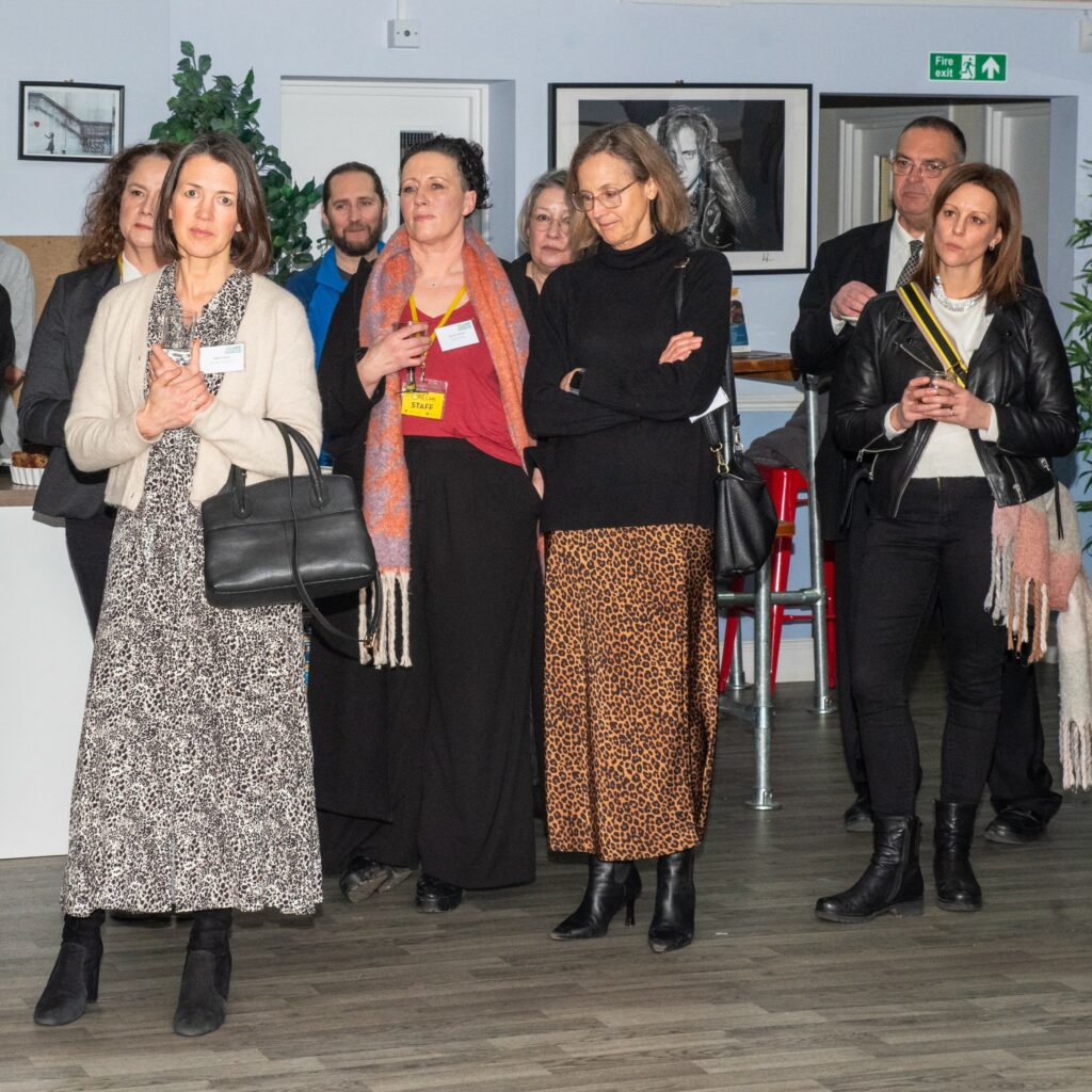 Guests at Community Advocates reception listening to the speeches