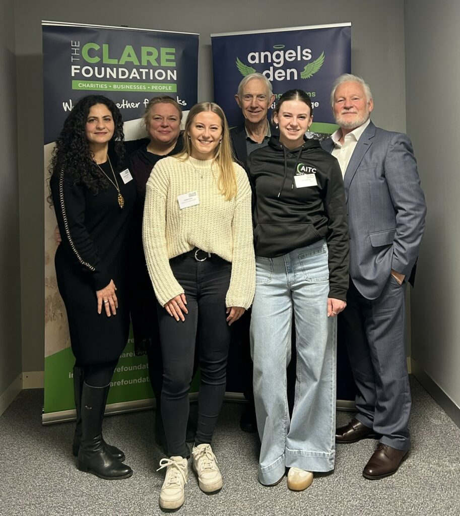 Martin Gallagher, TCF CEO, and attendees (6 people) standing in front of TCF banners